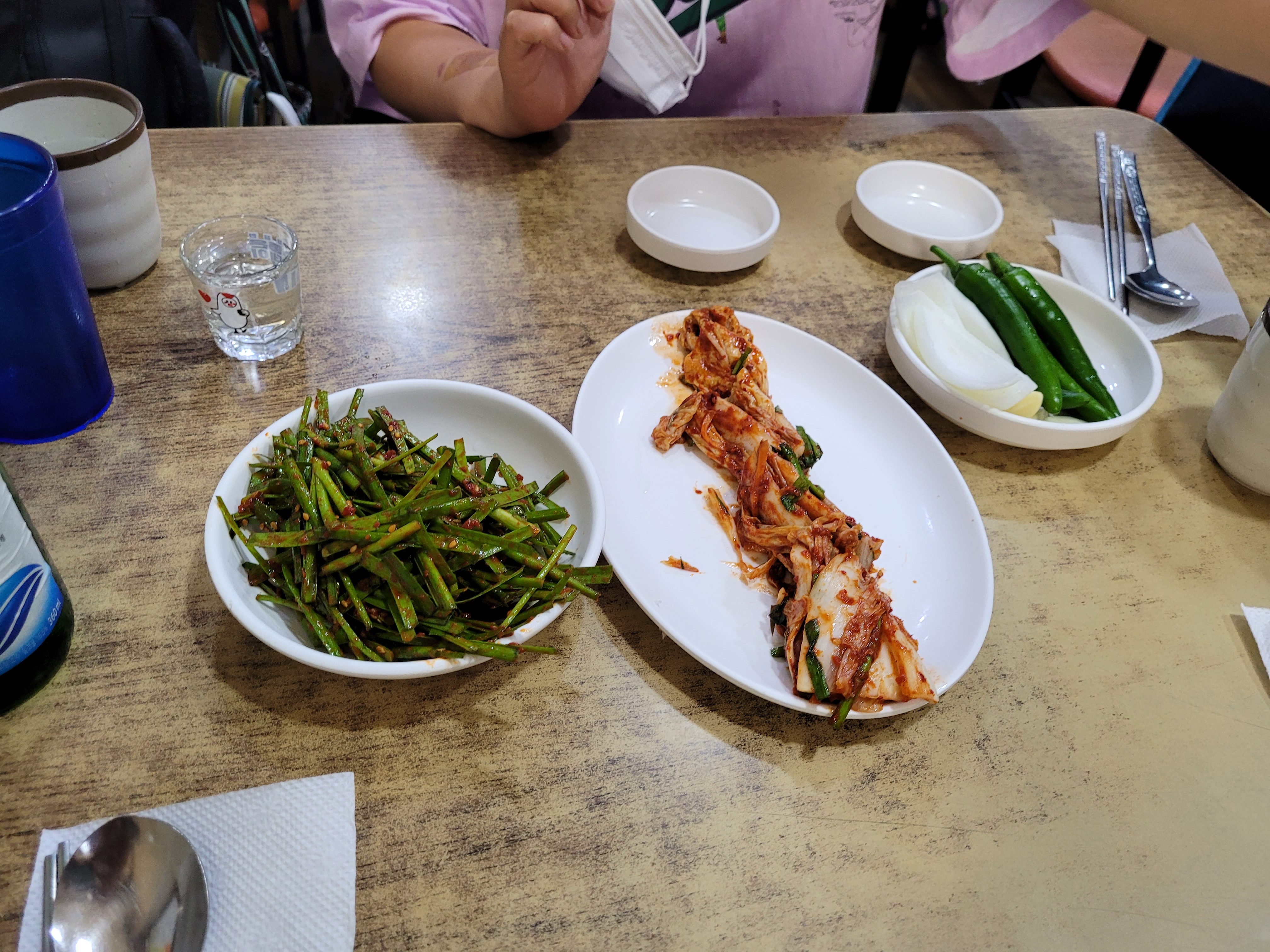 한상 가득 김치, 부추무침, 청양고추, 양파, 소주잔