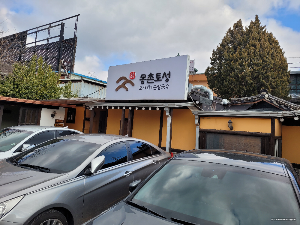 몽촌토성 식당 건물, 보리밥 손칼국수 간판, 주차된 차량