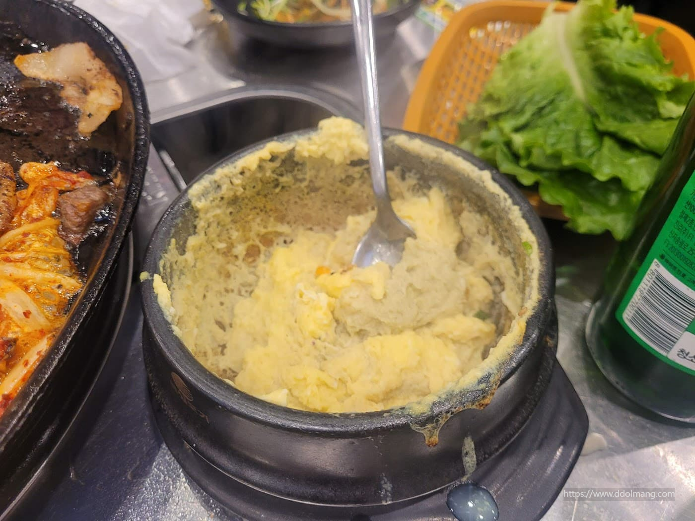 검은 뚝배기 부드러운 계란찜, 고기 불판과 상추 곁들여