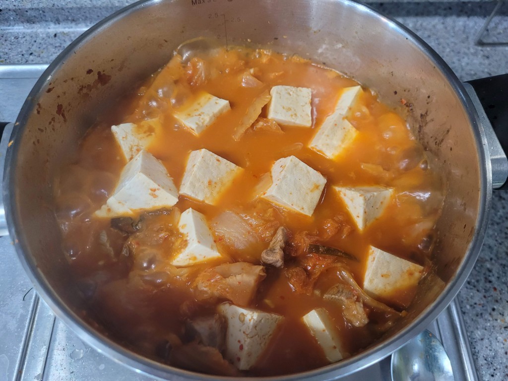 냄비 속 깍둑썰기 두부, 돼지고기 김치찌개 보글보글 끓는 중